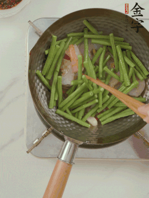 下掰好的缸豆段翻炒，略燜煮。